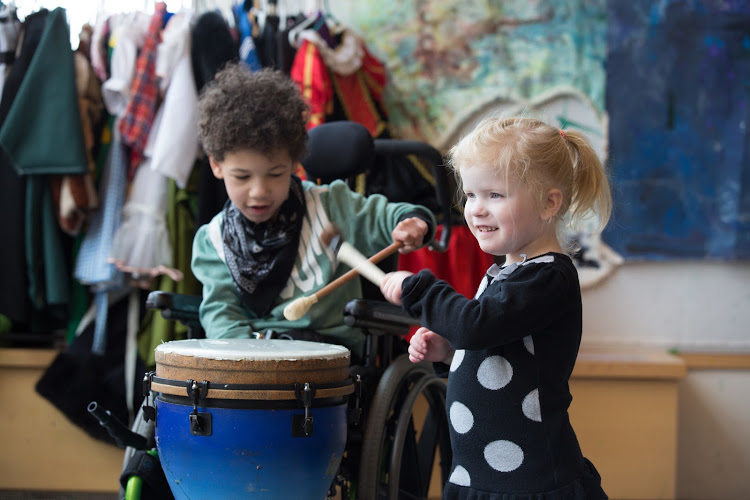 boy and girl playing drums