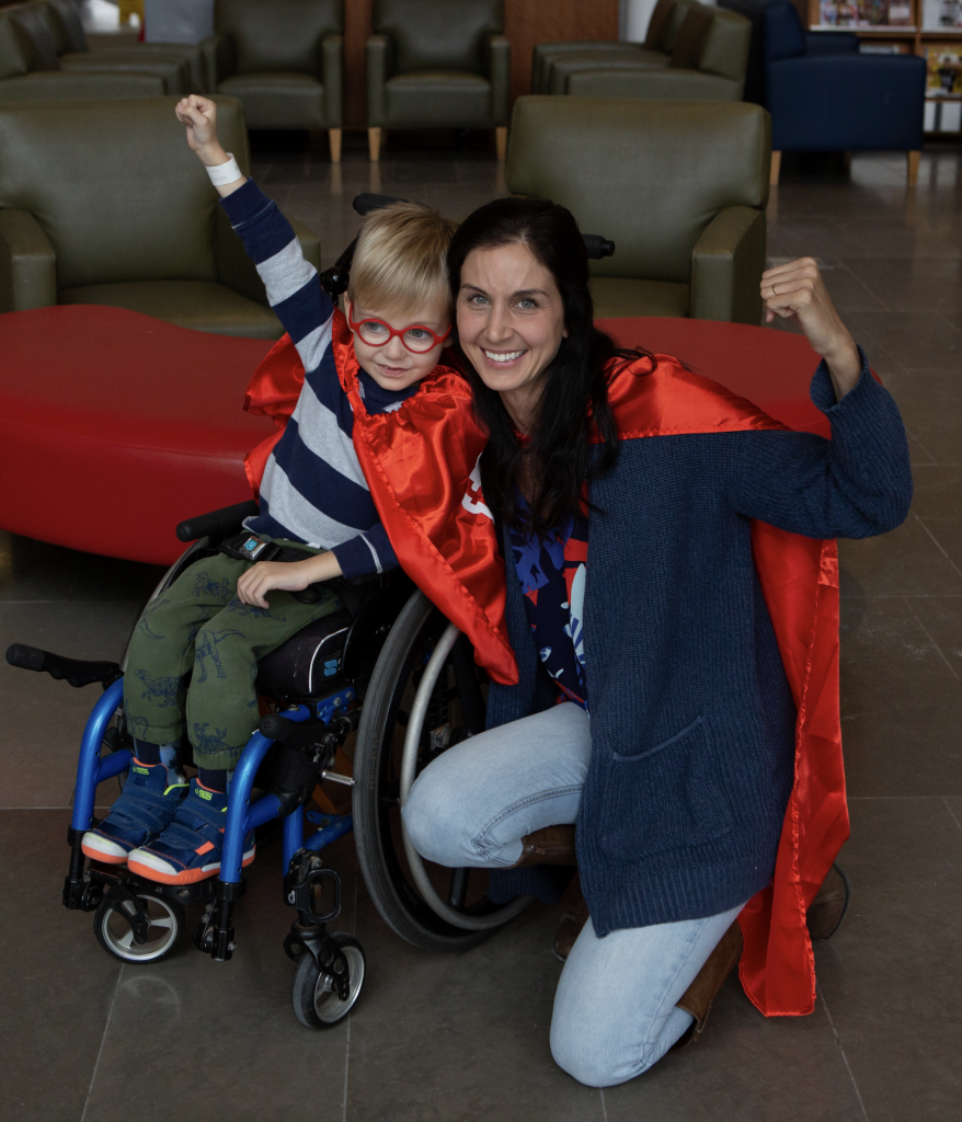mother and son wearing capes smiling