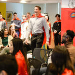 A workplace fashion show team building activity for Capes for Kids