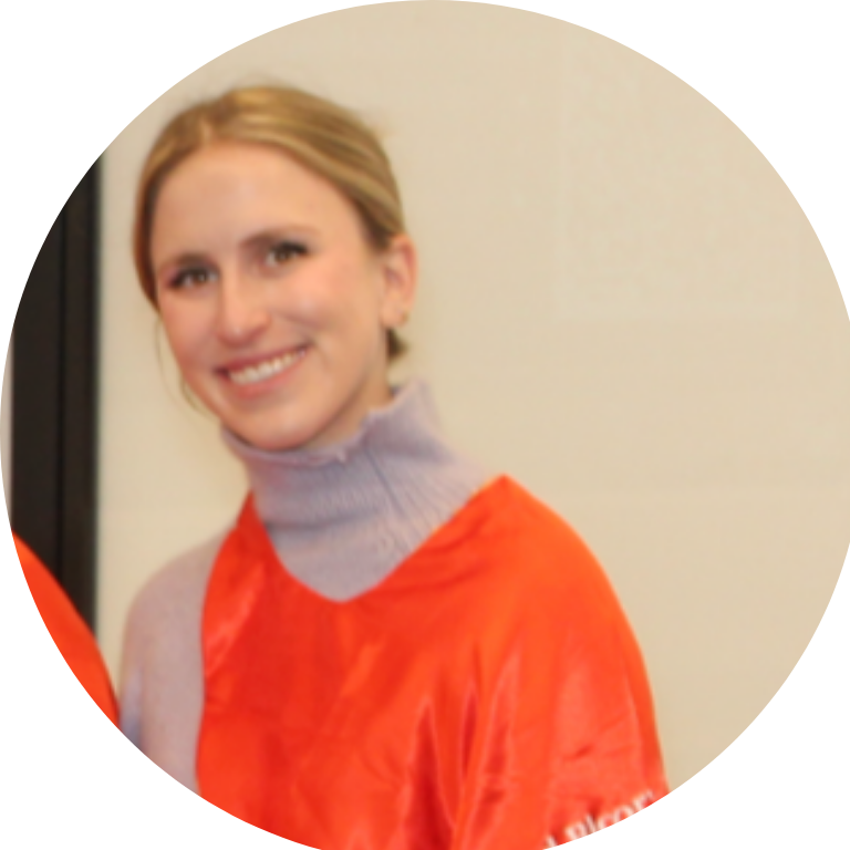 An adult wearing a red cape